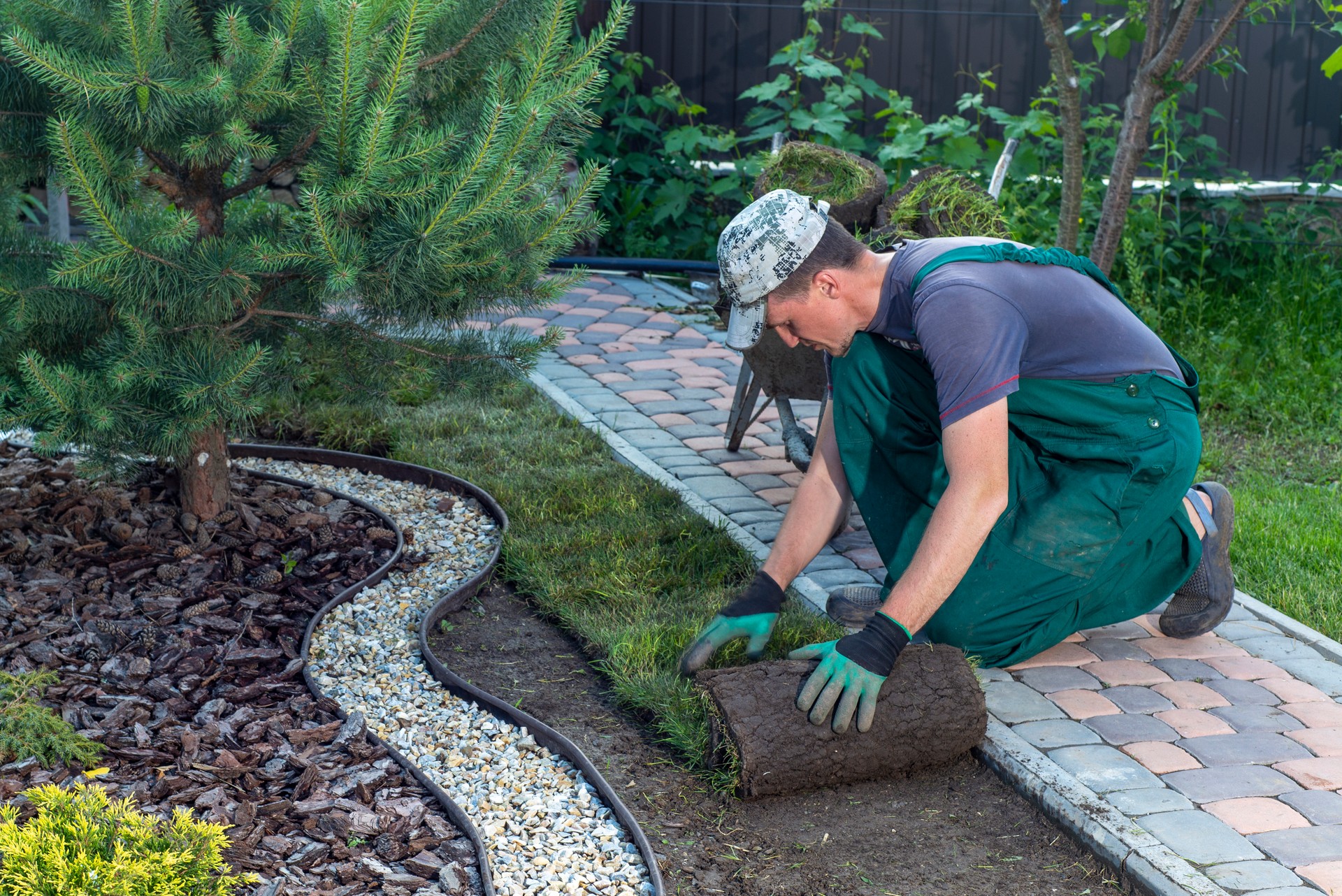 Landscape Gardener Laying Turf For New Lawn